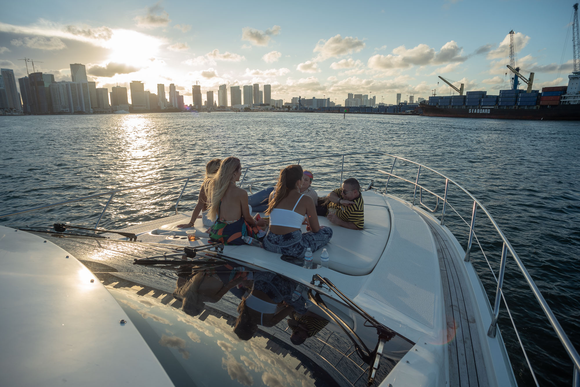 Group enjoying a sunset during a boat rental excursion